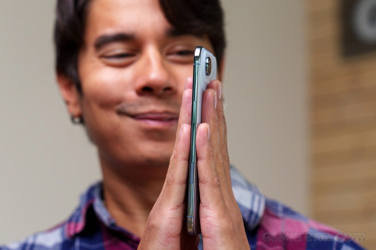Man holding phone, smiling, 2025 Apple article