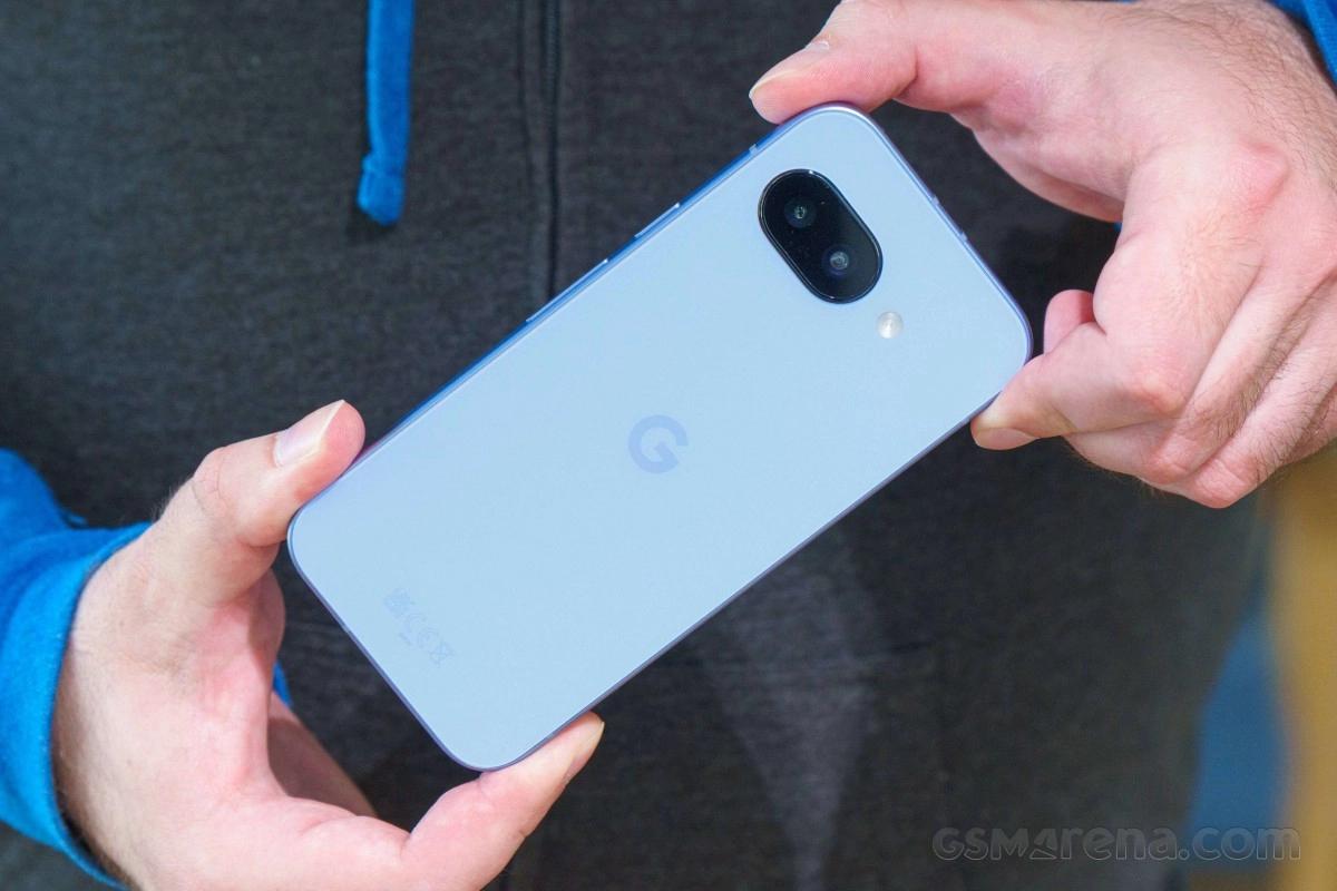 Hands holding light blue Google Pixel smartphone.
