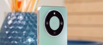 Mint green phone with circular camera module.