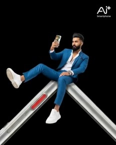 Man takes selfie, sitting on Ai+ NovaFlip foldable.