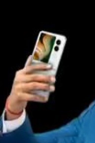 Person holding Ai+ NovaFlip white smartphone.